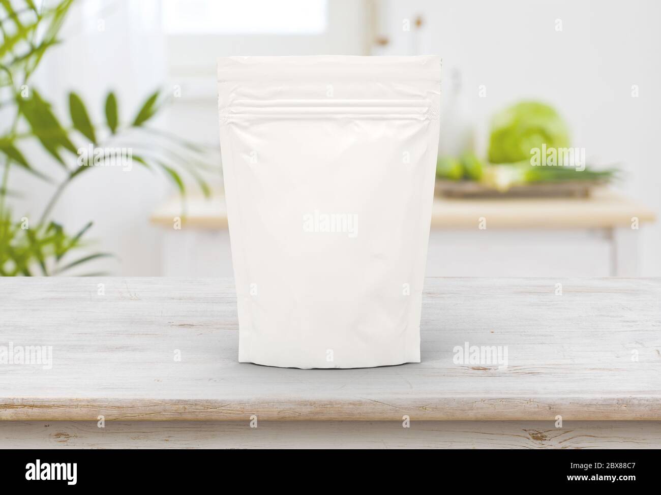 The white food and snack pouch bag packaging mock-up design front view on wooden table Stock Photo