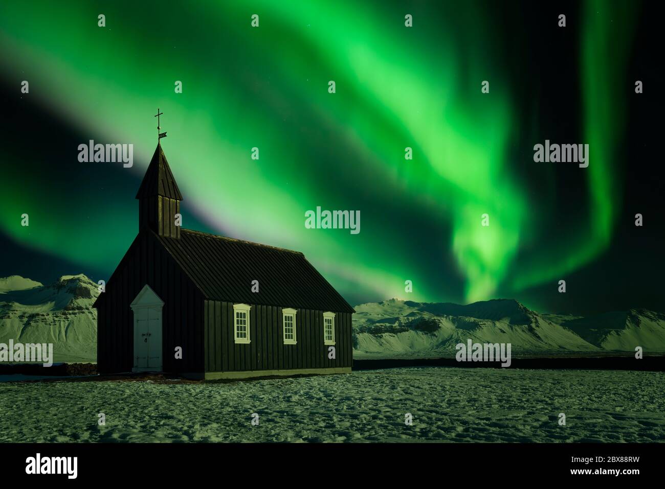 Northern lights over a small black church. Aurora borealis over one of simplest churches in the world in Búðakirkja, Iceland Stock Photo