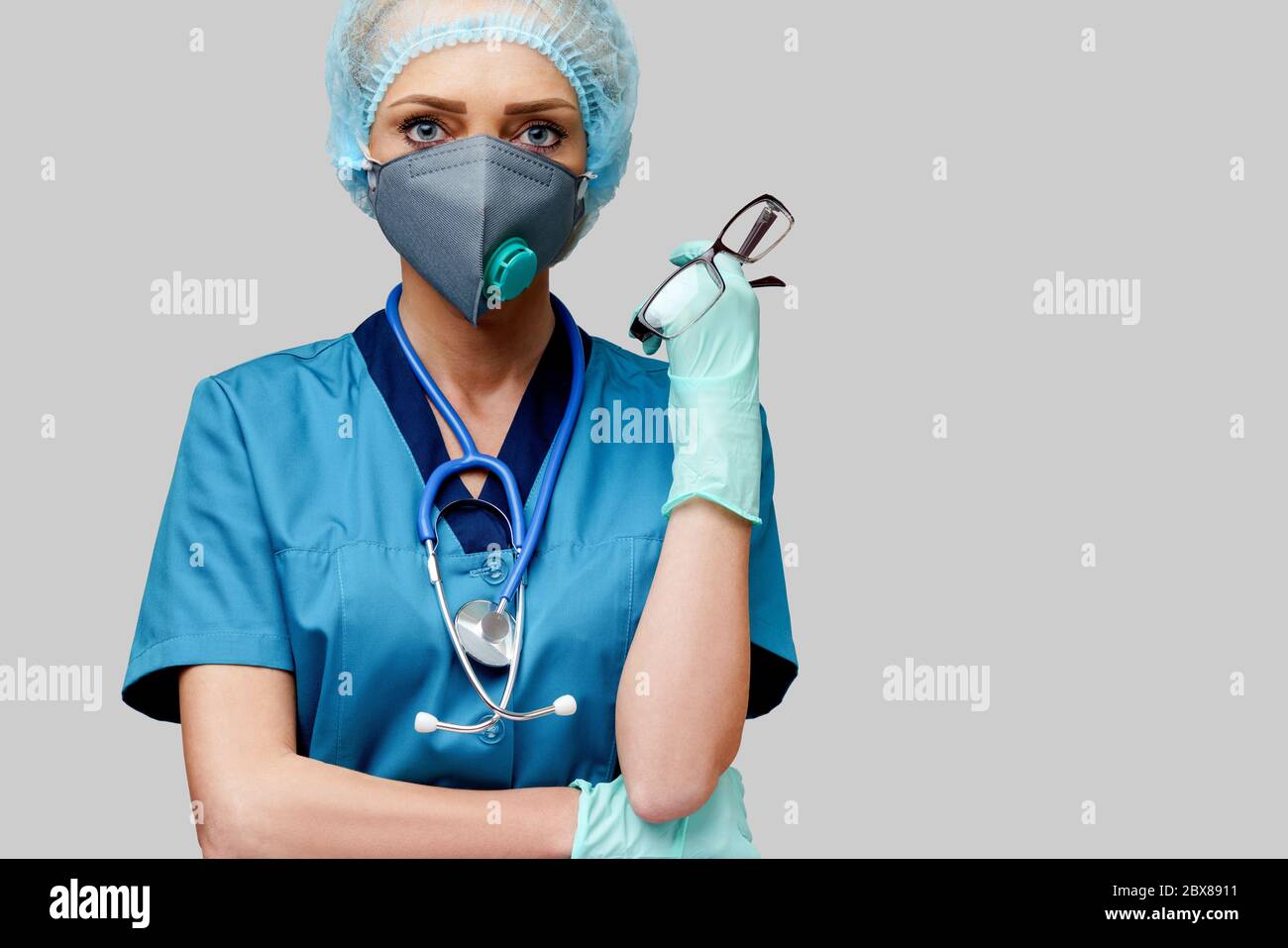 female doctor with stethoscope wearing protective mask and latex gloves ...