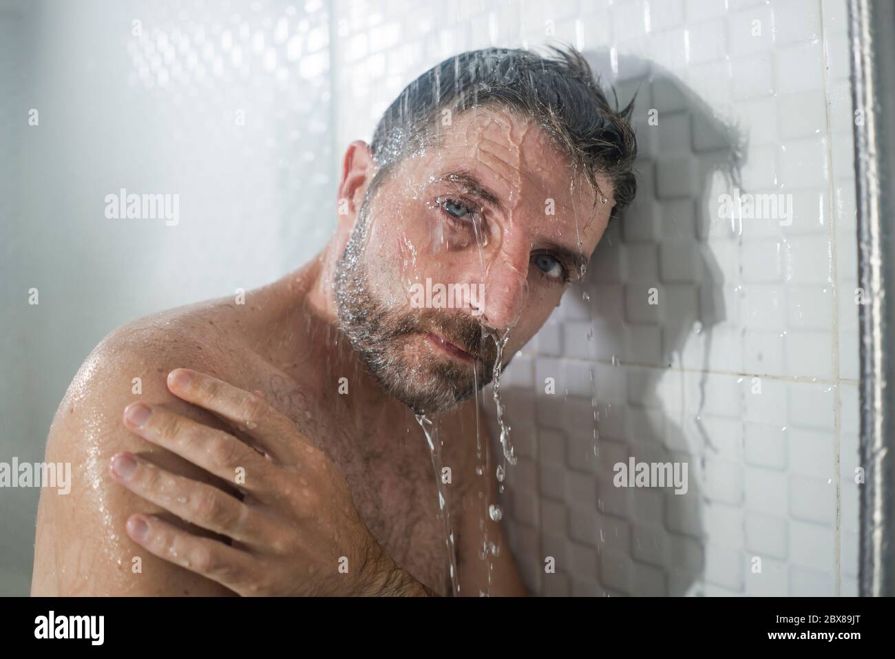 home bathroom dramatic portrait of young attractive sad and depressed