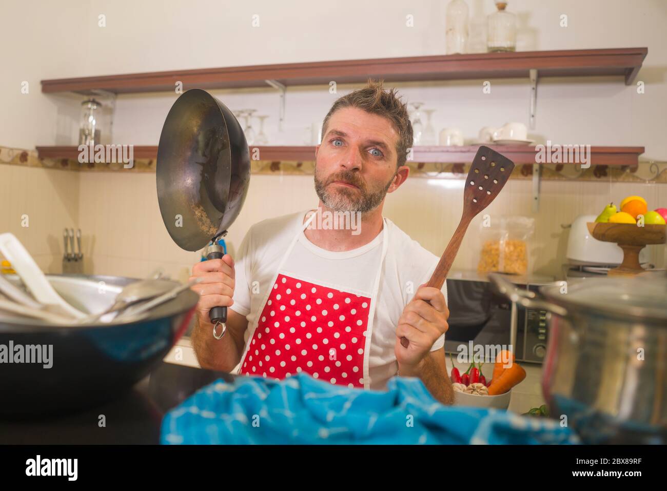 Overworked Cook domestic chores stress - young attractive overworked and depressed man ...