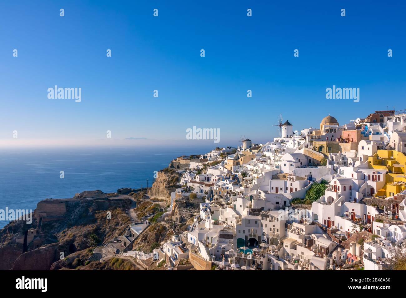 Greece. Santorini (Thira island). White houses and windmills on a mountainside in the village of Oia Stock Photo