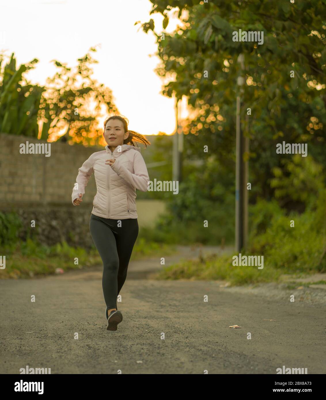 Outdoors Running Workout Young Happy And Dedicated Asian Chinese Woman Jogging At Beautiful City Park Or Countryside Trail On Sunset Enjoying Fitnes Stock Photo Alamy