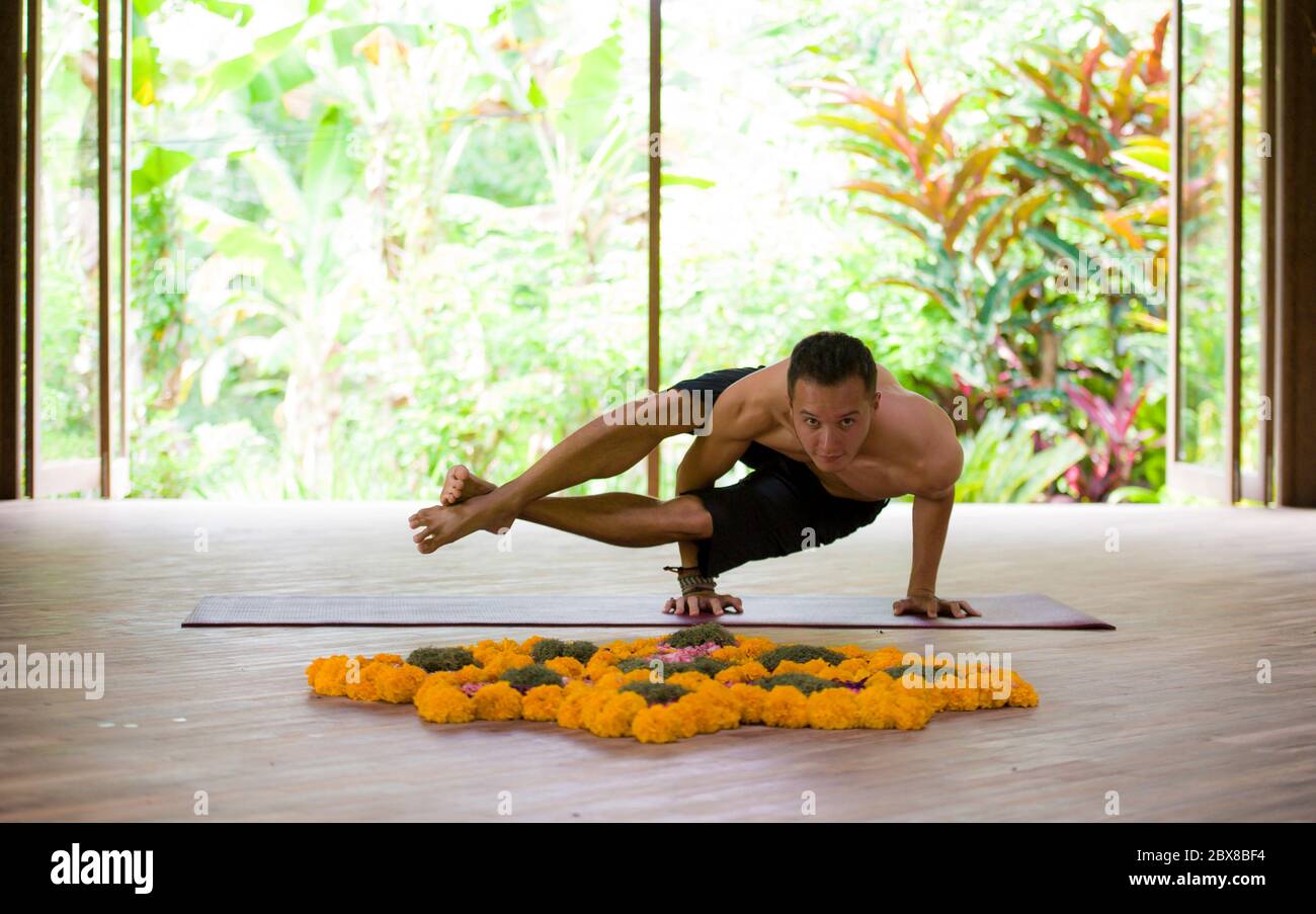 natural portrait of young attractive and fit acrobat man practicing ...