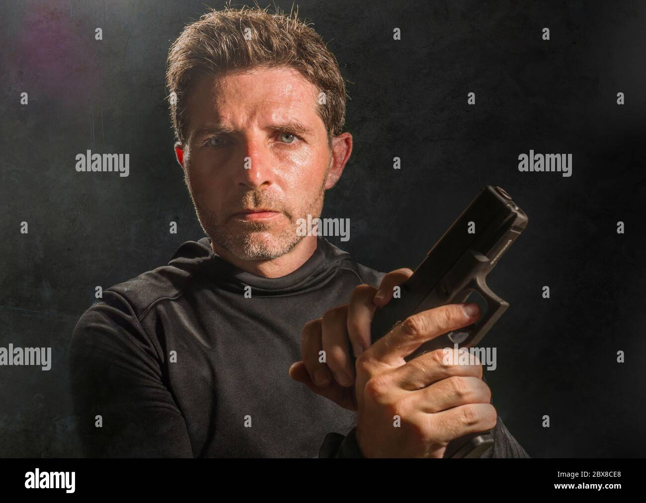 action portrait of serious and attractive hitman or special agent man