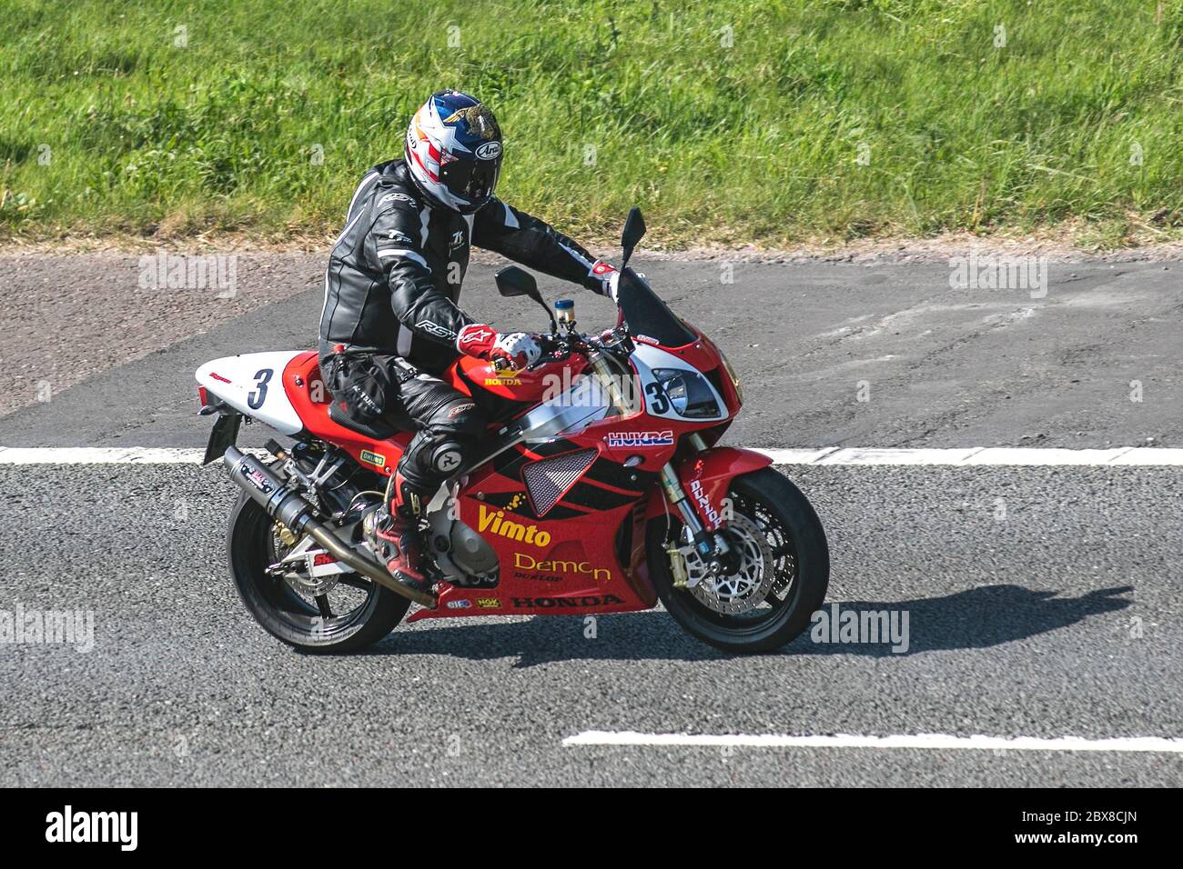 Red black Honda Motorbike rider; two wheeled transport, racing 