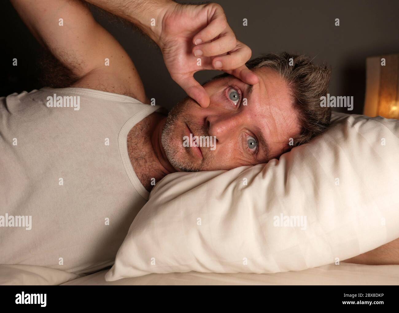 Плохой сон. Недосыпание. Человек страдающий бессонницей. Страдающий бессонницей. Мужчина проснулся.