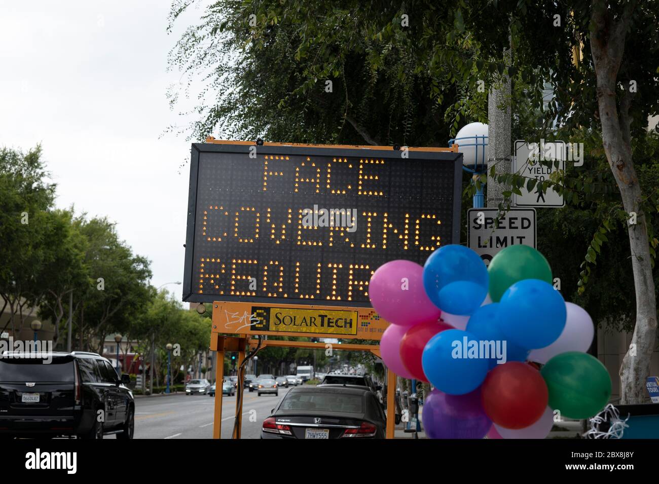 West Hollywood, CA/USA - June 5, 2020: Despite days of Black Lives Matter protests on the streets, a road sign still reads Face Covering Required for Stock Photo
