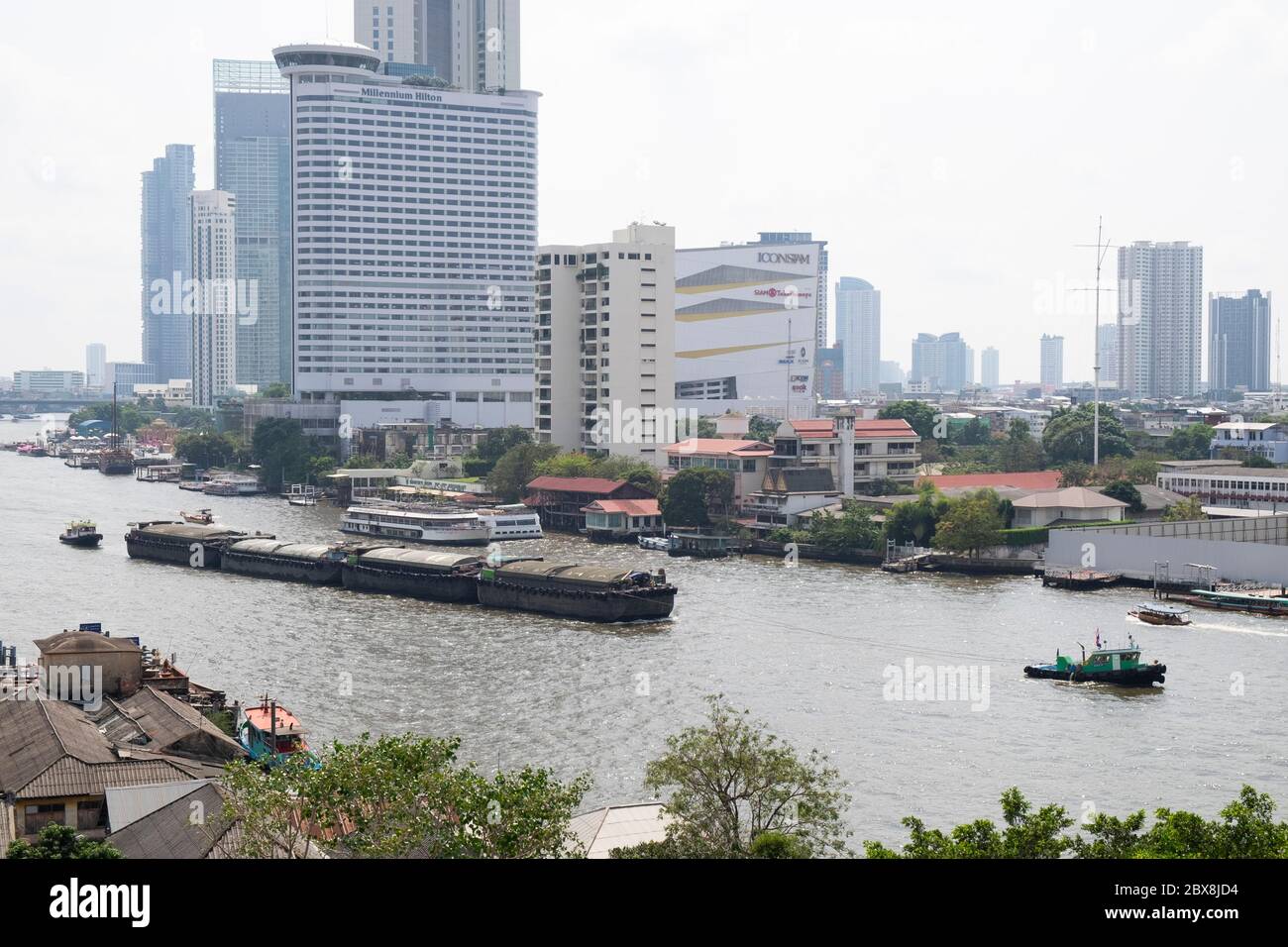 Tug boat pulling a barge on the Chao Praya river, Bangkok, Thailand, Southeast Asia. Stock Photo