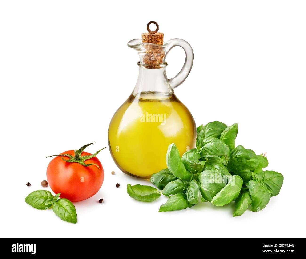 Glass jar of olive or vegetable oil with basil leaves and tomato ...