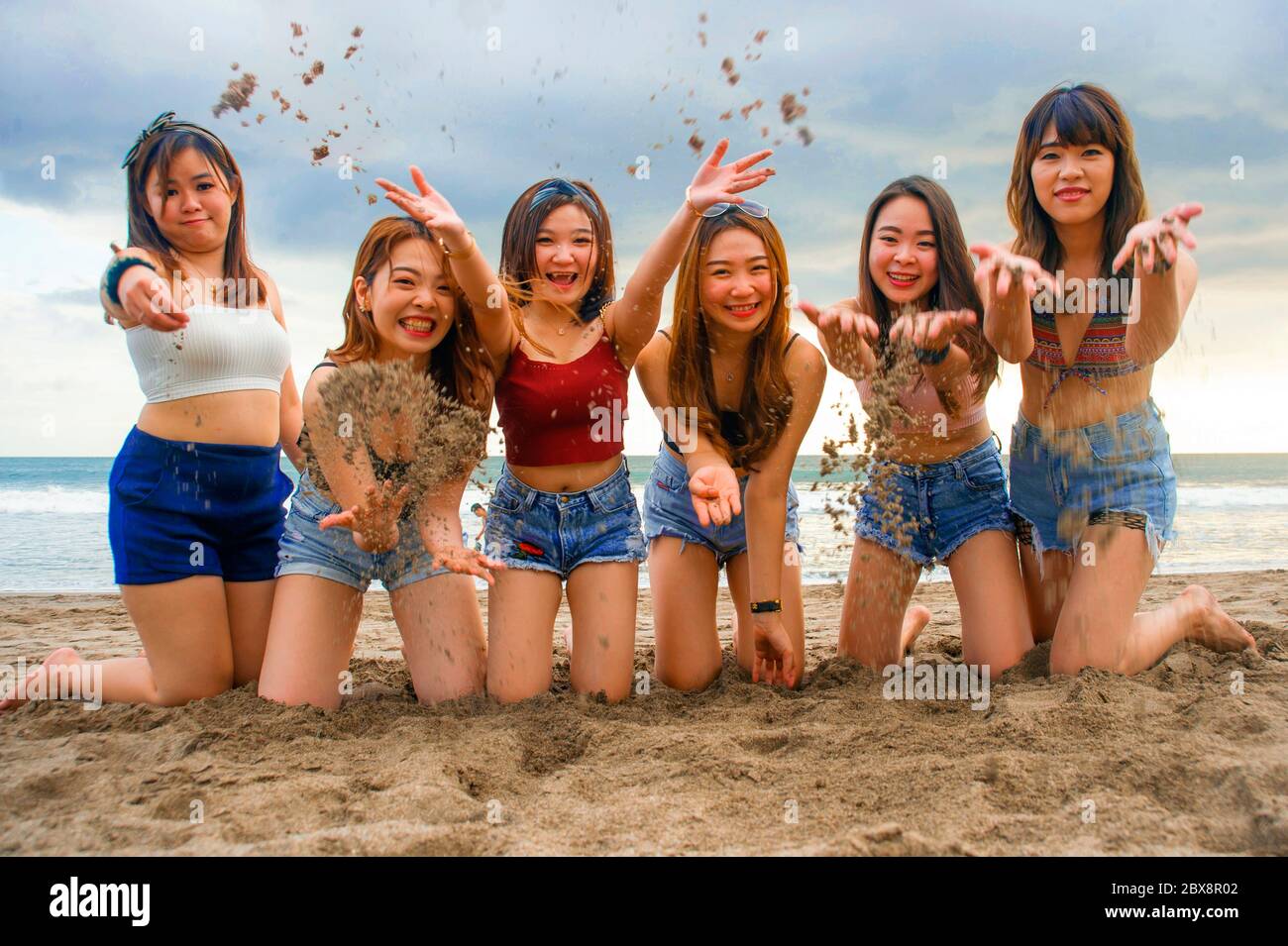 Girls kneeling in the sea hi-res stock photography and images - Alamy