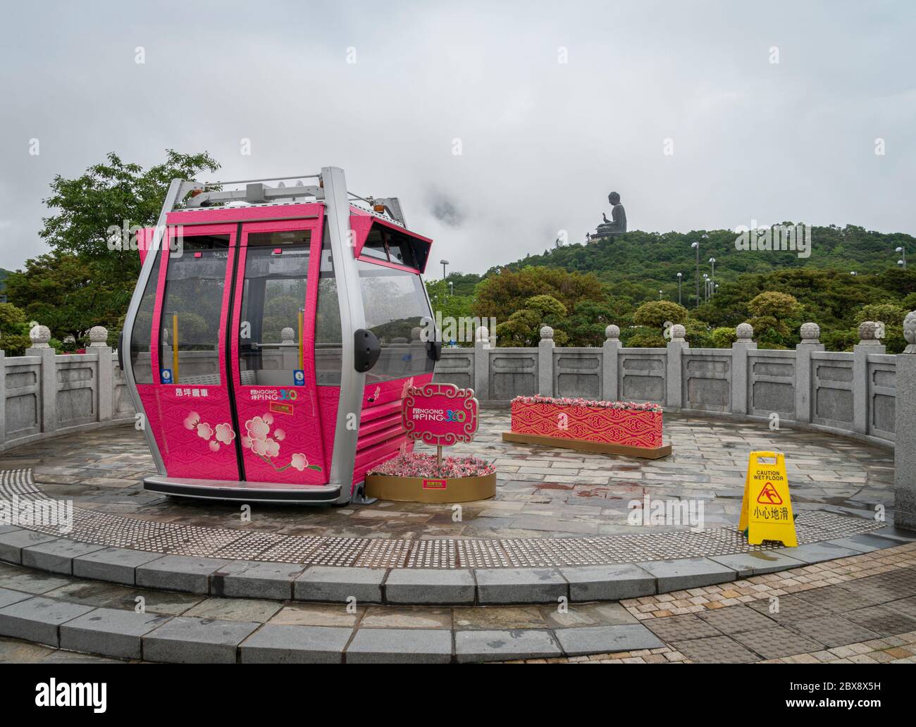 View of a Ngong Ping 360 cable car with the Tian Tan Big Buddha in the  distance, Lantau Island, Hong Kong Stock Photo - Alamy