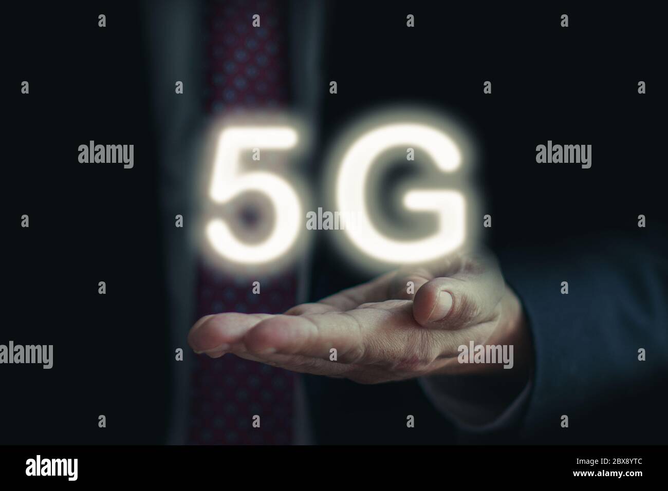 Businessman hold 5G network interface logo on his hand Stock Photo