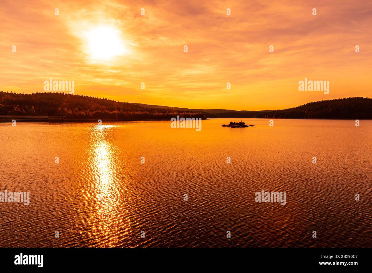 Sunset reflected in water. Josefuv Dul Dam, Jizera Mountains, Czech Republic. Stock Photo