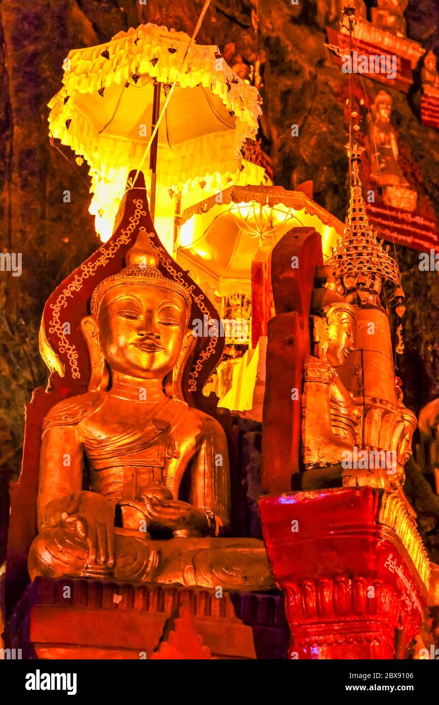 Golden Buddha statues in Pindaya Cave located next to the town of Pindaya, Shan State, Burma, Myanmar are a Buddhist pilgrimage site and a tourist att Stock Photo