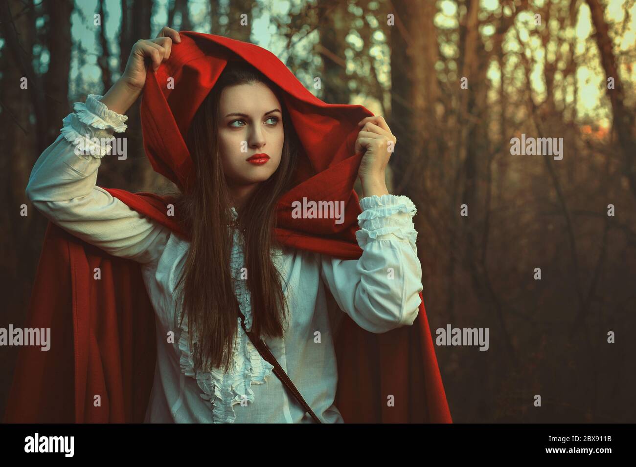 Portrait With Dark Tones Of Little Red Riding Hood In The Woods Stock Photo Alamy