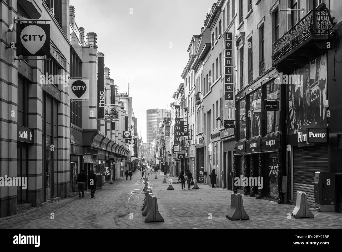 Shops on Rue Neuve (the main shopping street) in the centre of the Brussels city - Concrete barriers for counter terrorism in  Brussels, Belgium Stock Photo