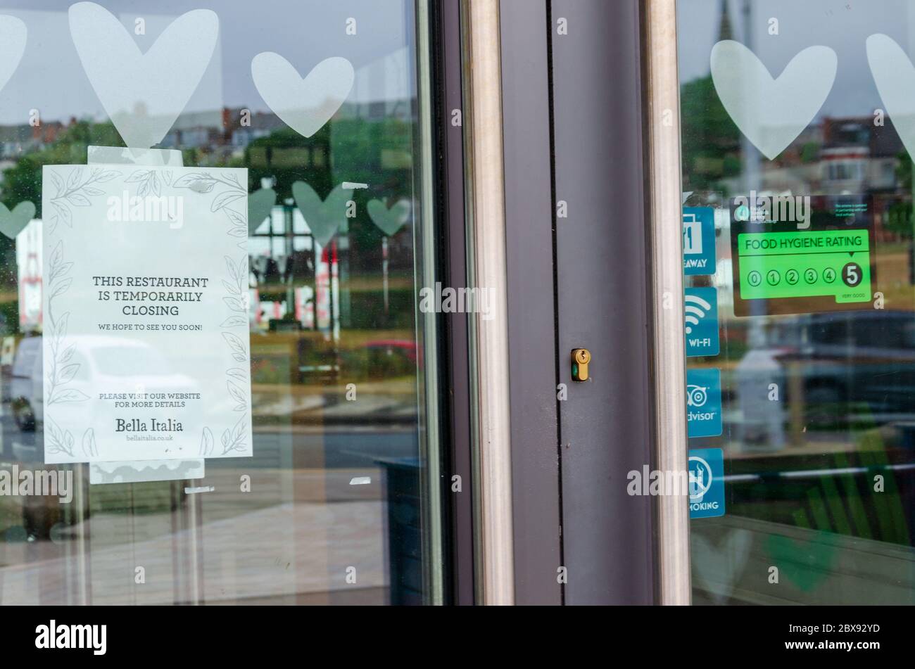 New Brighton, UK: Jun 3, 2020: A poster displayed in the window of a Bella Italia restaurant states that the business is closed. This is due to the co Stock Photo