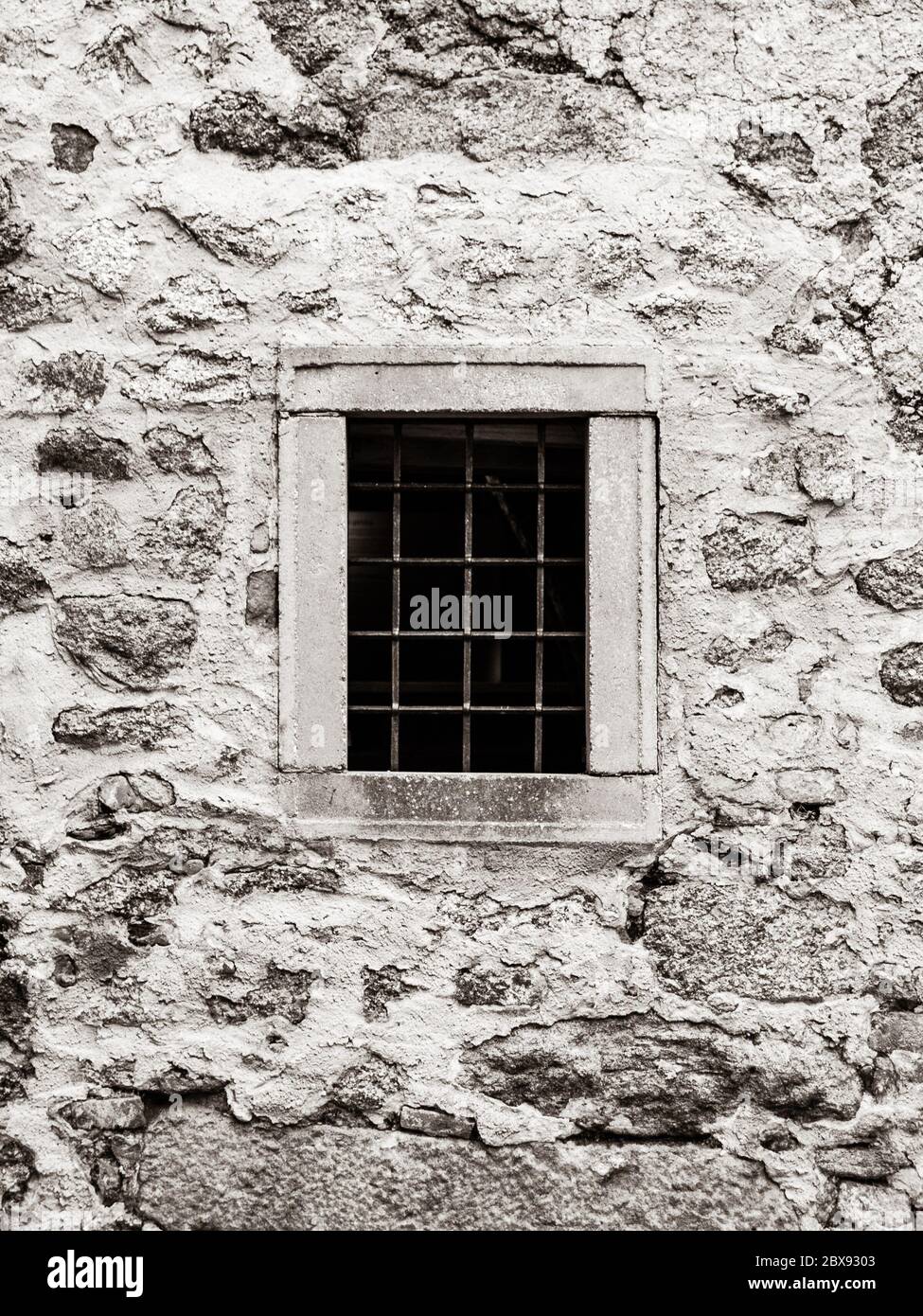 Old prison jail window with rusty metal bars. Vintage style image. Stock Photo