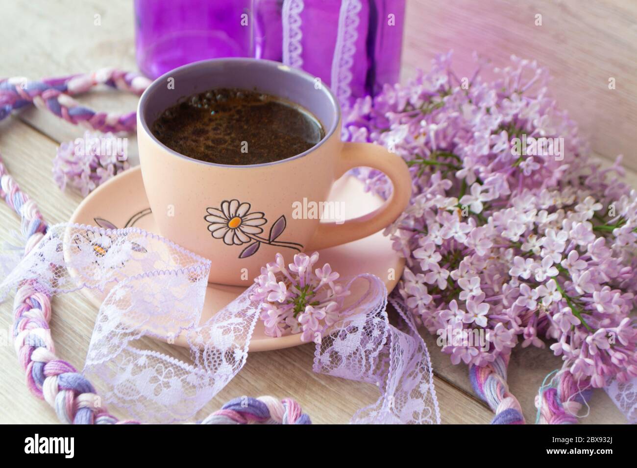 https://c8.alamy.com/comp/2BX932J/violet-cup-of-morning-coffee-or-cappuccino-and-delicate-purple-lilac-flowers-mothers-day-concept-cozy-breakfast-2BX932J.jpg