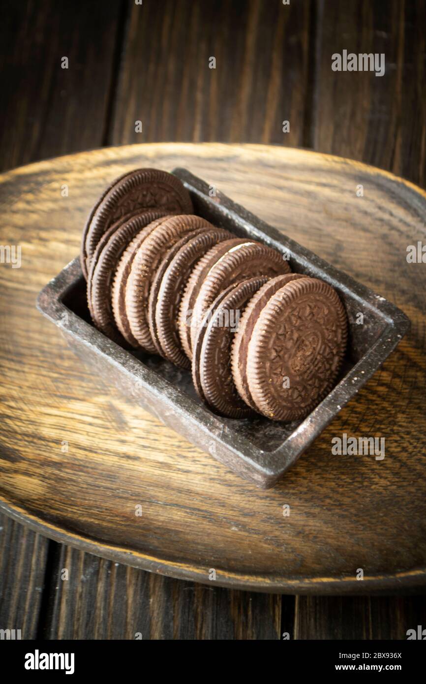 Dark cookie of two chocolate wafers with a sweet creme filling in