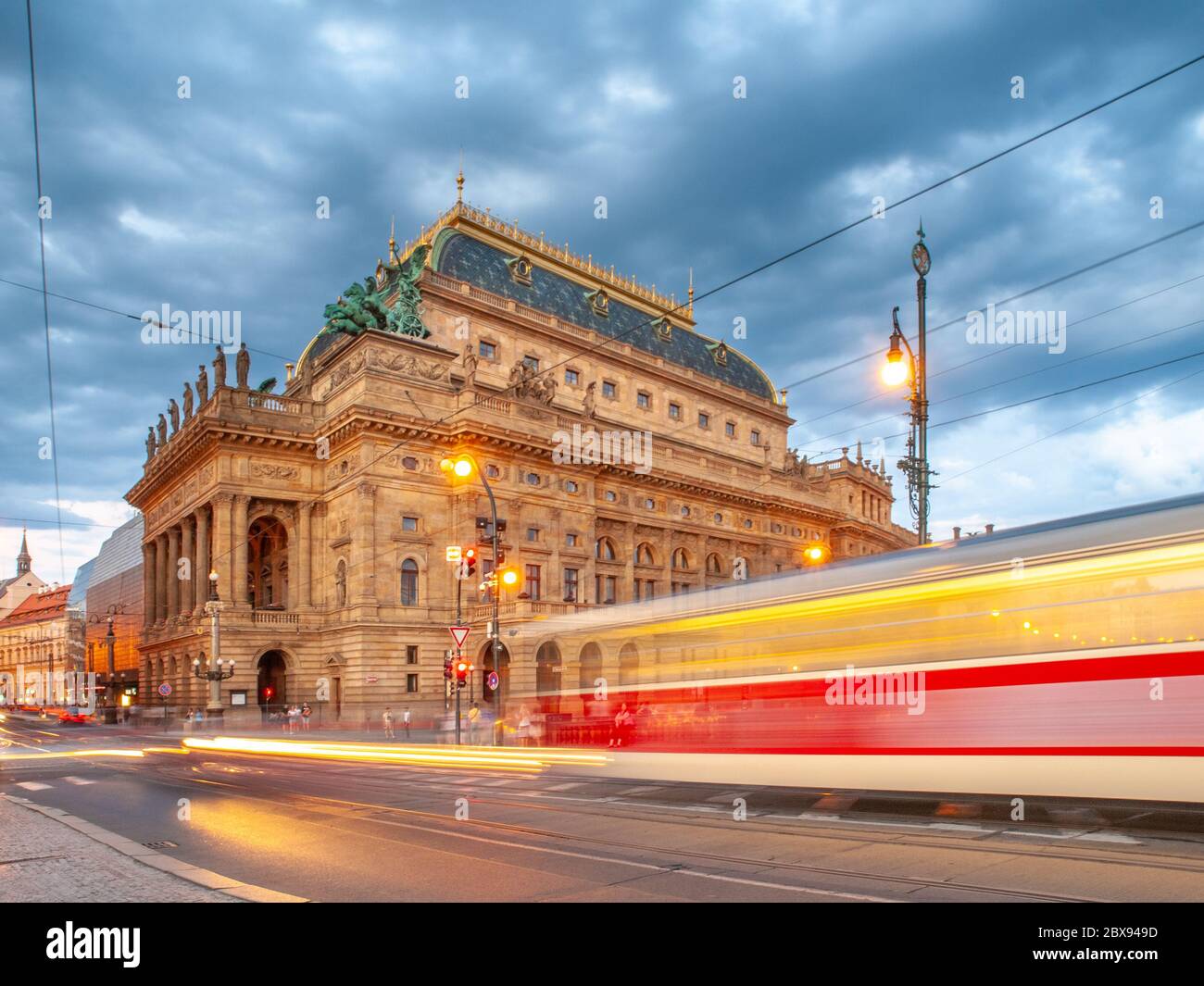 Evening at National Theater and blurred tram on the bridge, Prague, Czech Republic. Long exposure shot. Stock Photo