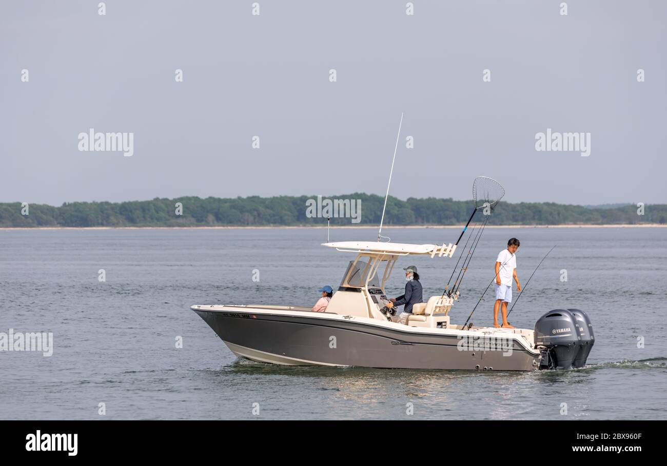 Family on a fishing boat with Shelter Island, NY in the background Stock Photo