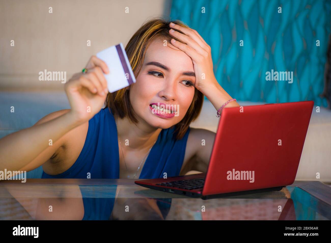 lifestyle portrait of young attractive and upset woman at home couch