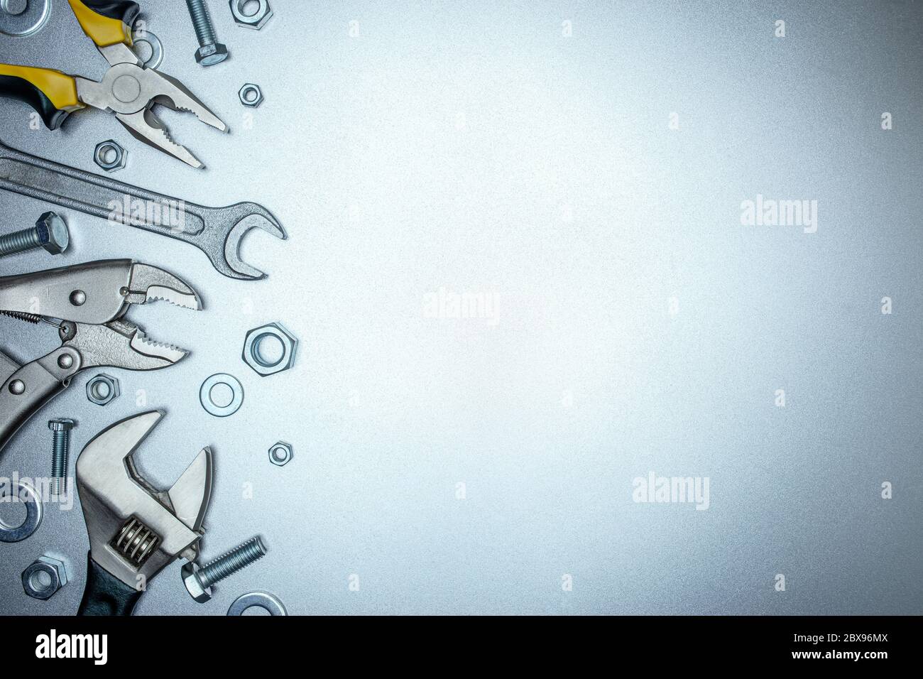various renovation instruments and working tools on grey metal background Stock Photo