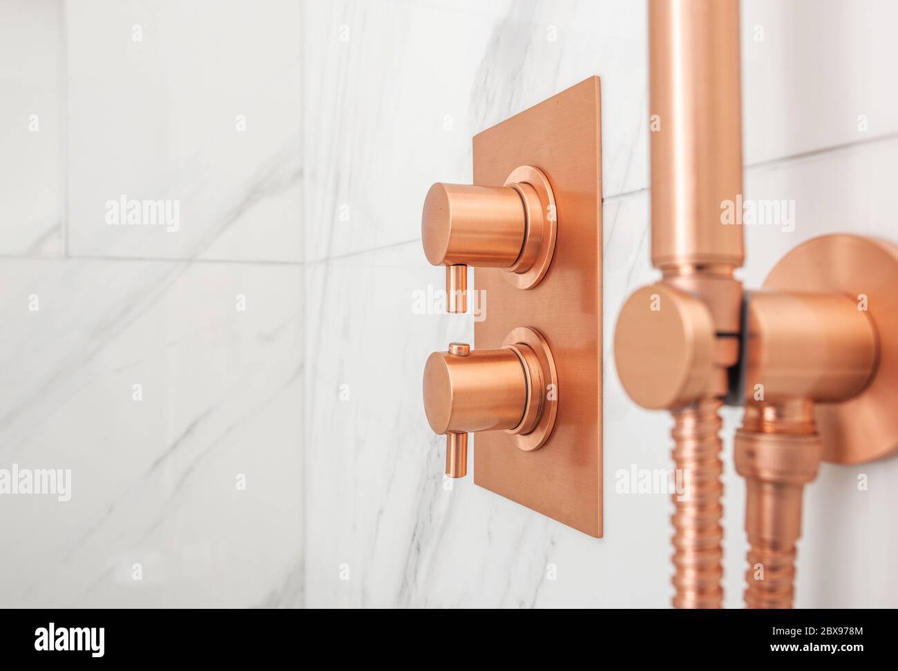 Elegant Copper Metallic Bathroom Shower Water Control Valves and Stylish Shower Head Close Up