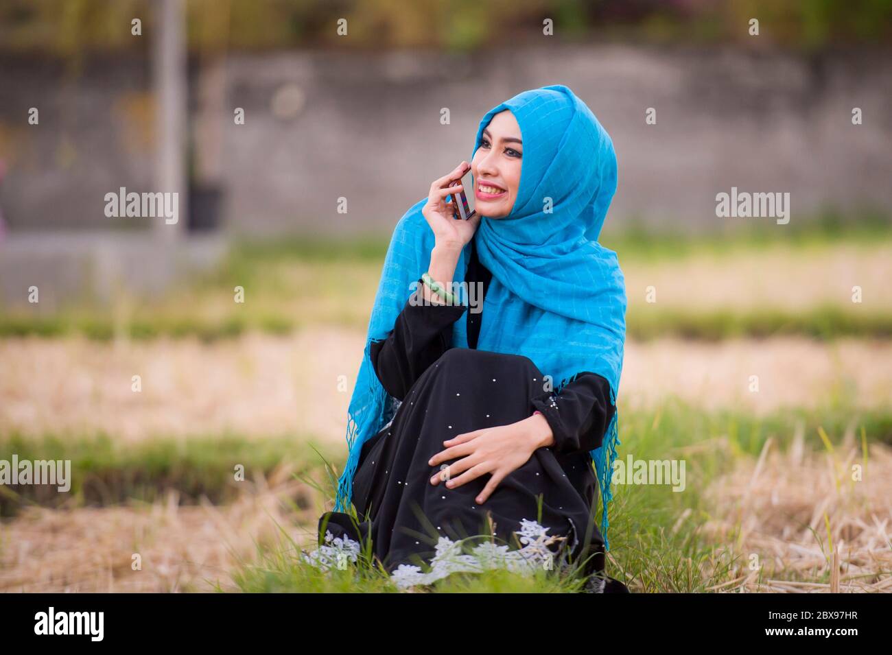 young beautiful and happy muslim woman wearing islamic hijab head scarf ...