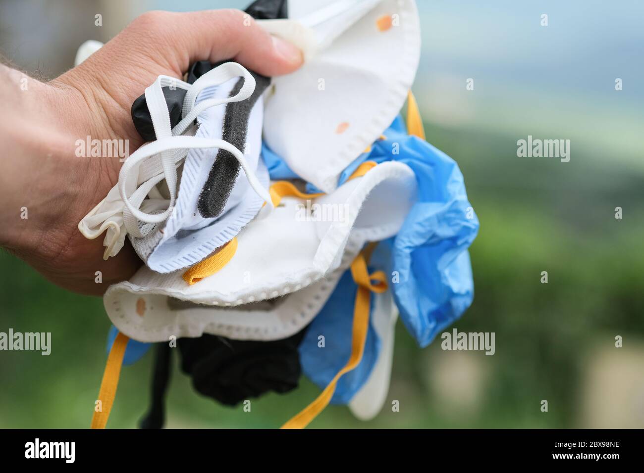 Guy collect Medical dirty waste mask and gloves garbage,coronavirus disease equipment Stock Photo