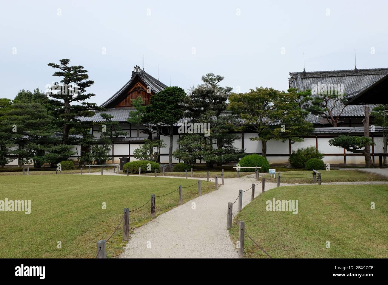 Pristine lawns and lovingly tended gardens surround the magnificant buildings of Niji Castle in Kyoto Stock Photo