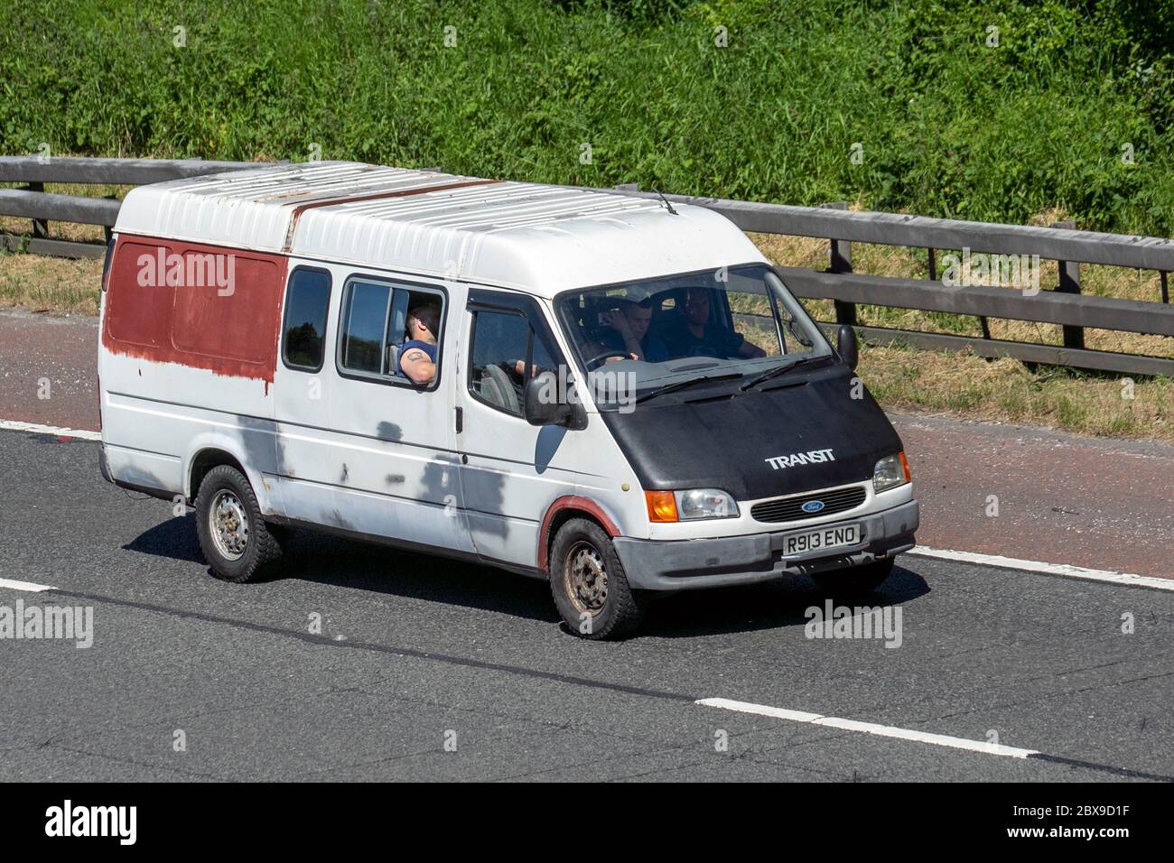 1998 90s Ford Transit 190 LWB Rusty old white van; Vehicular traffic moving vehicles, cars driving vehicle on UK roads, modified 90s motors, motoring on the M6 motorway Stock Photo