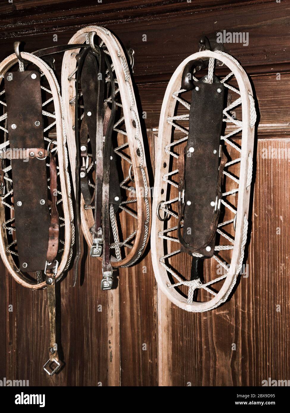 Vintage wooden snowshoes hanging on the wall in mountain cottage Stock