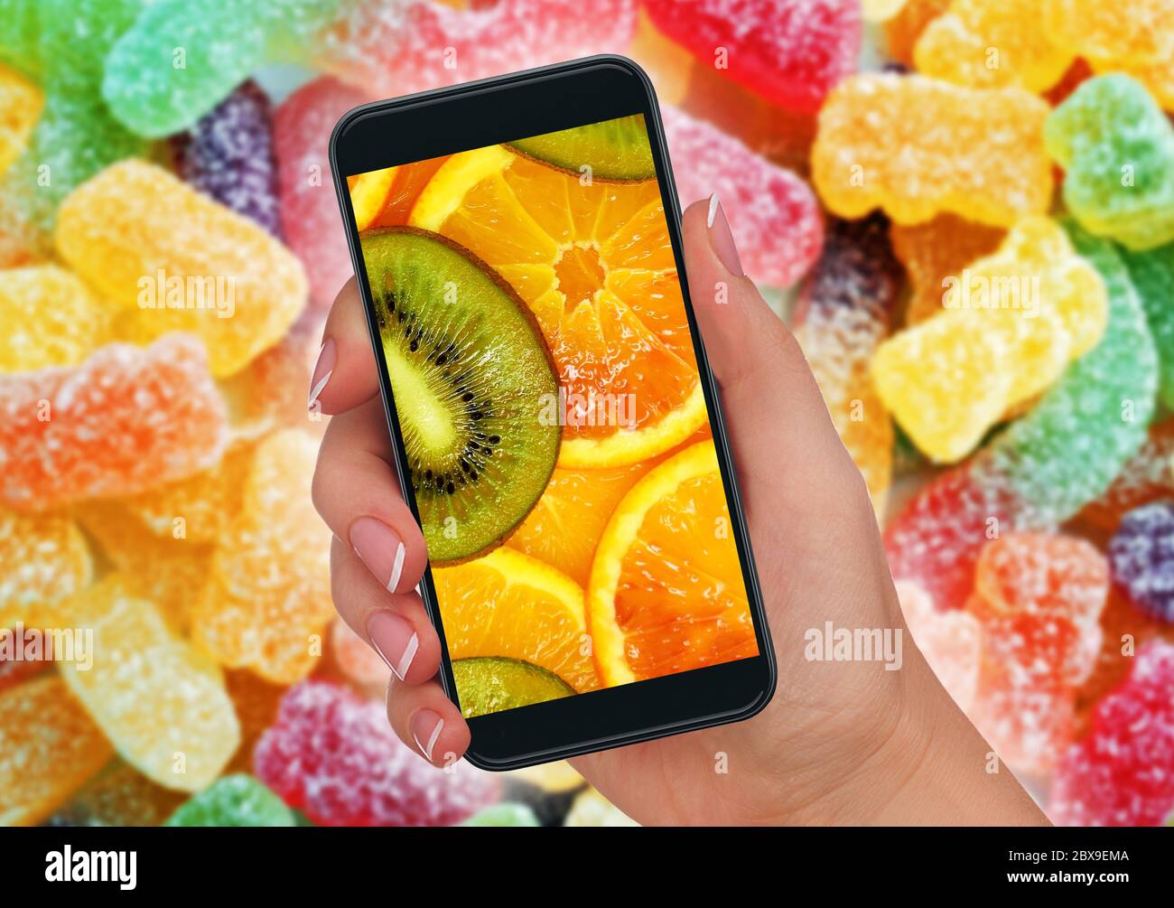 conceptual healthy nutrition and fresh fruits versus sweet citrus candy