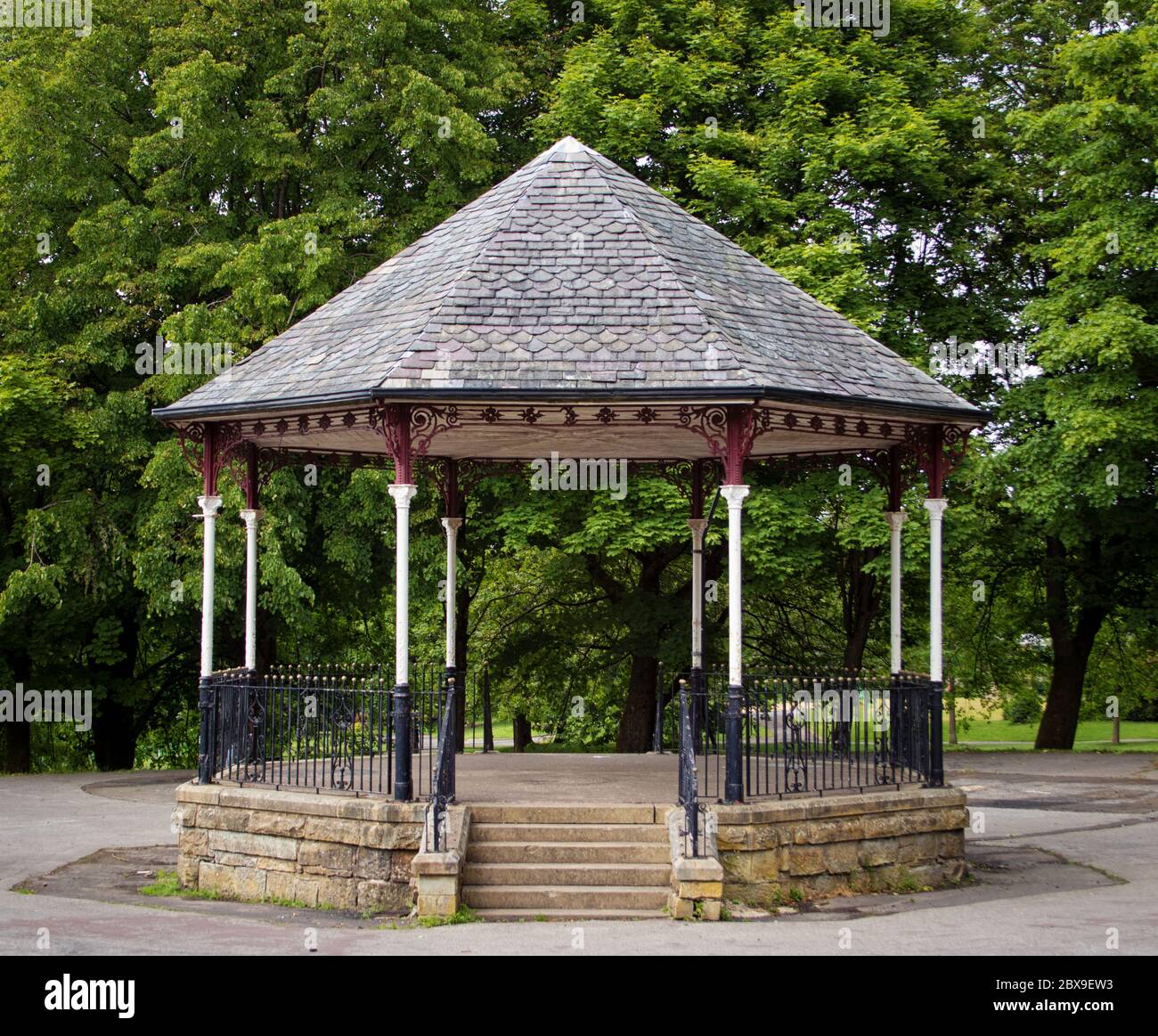 The bandstand, backed by trees, in Scott Park, Burnley, Lancashire