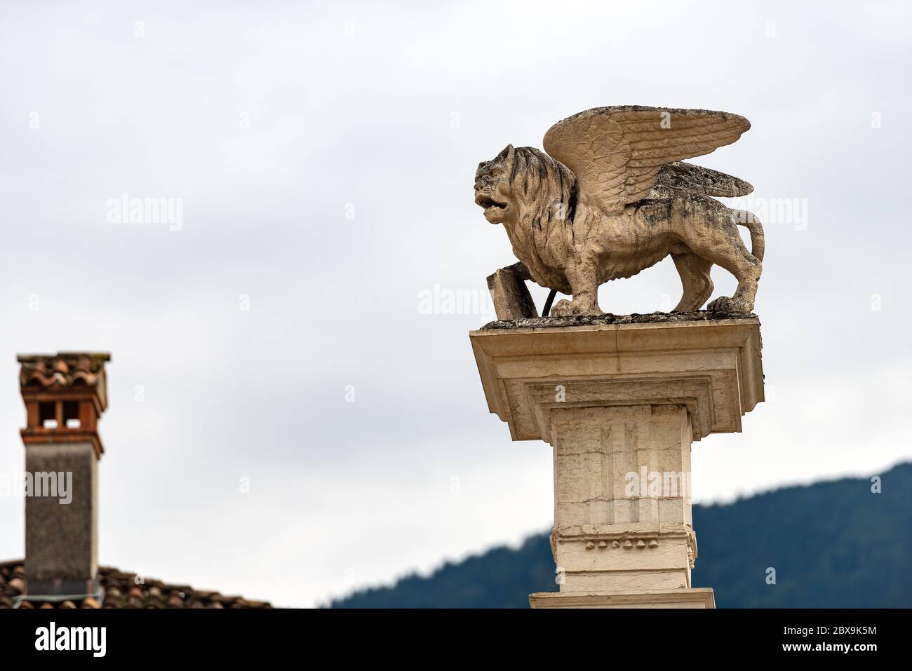 Winged lion of St Mark (Leone di San Marco) on the top of a column, symbol of the Venetian Republic. Piazza Maggiore, Feltre, Belluno province, Veneto Stock Photo