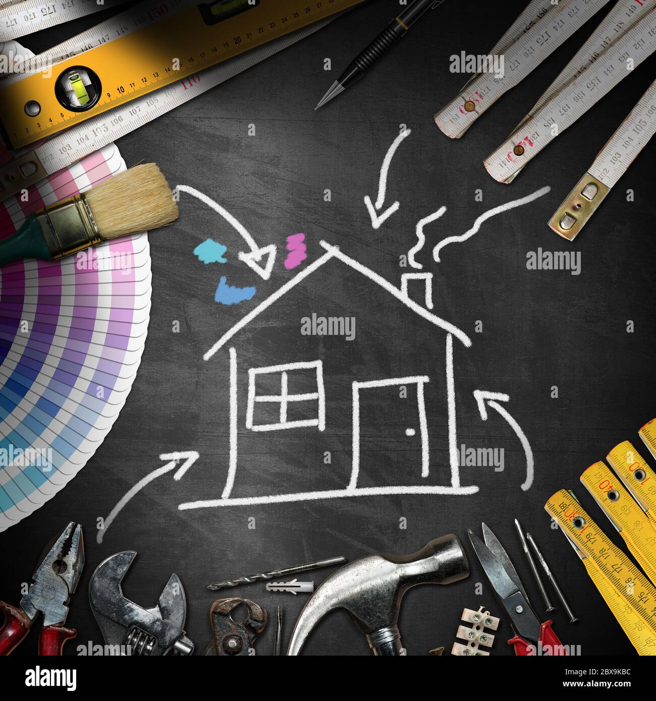 Home improvement concept - Black chalkboard with work tools and a chalk drawing of a house Stock Photo