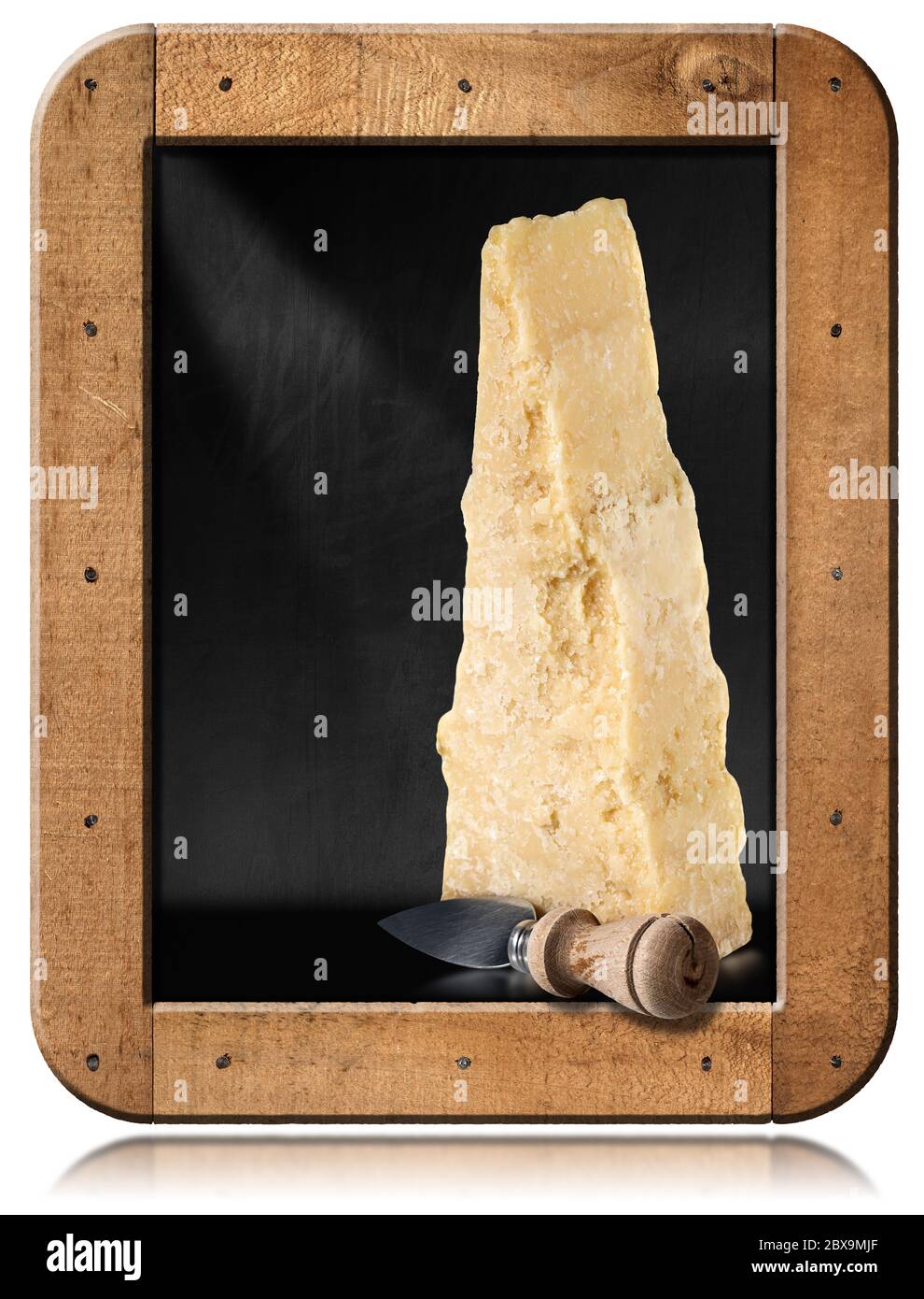 Slice of Italian Parmesan cheese with an old knife in a blackboard with wooden frame and copy space, isolated on white background Stock Photo
