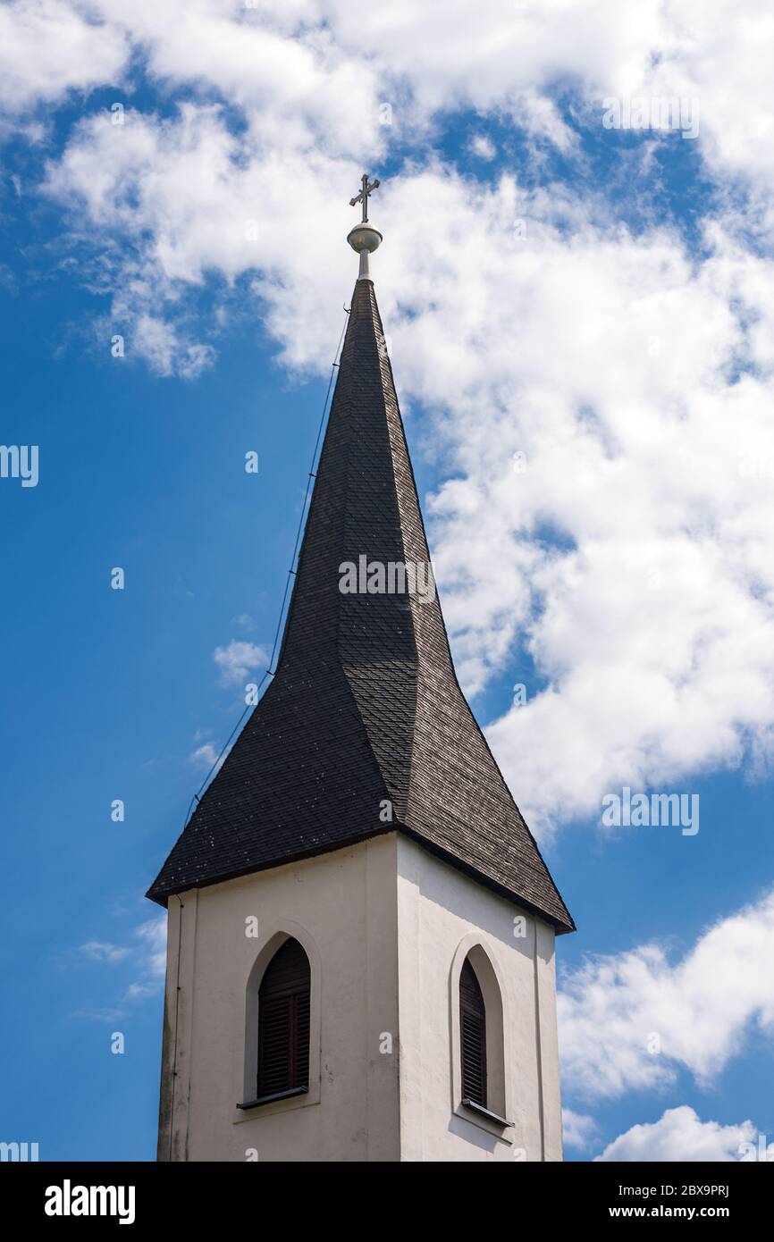 Bell tower of a small church in Austria, in the small village of Oberschutt, Villach, Carinthia, Austria, Europe. Church of St. Mary Magdalene Stock Photo