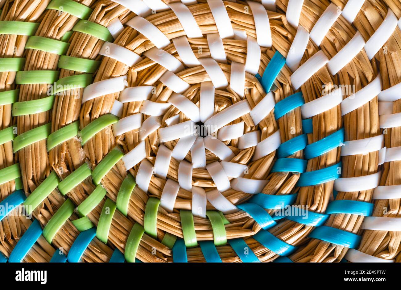 Wickerwork place mat with white, green and blue strings Stock Photo