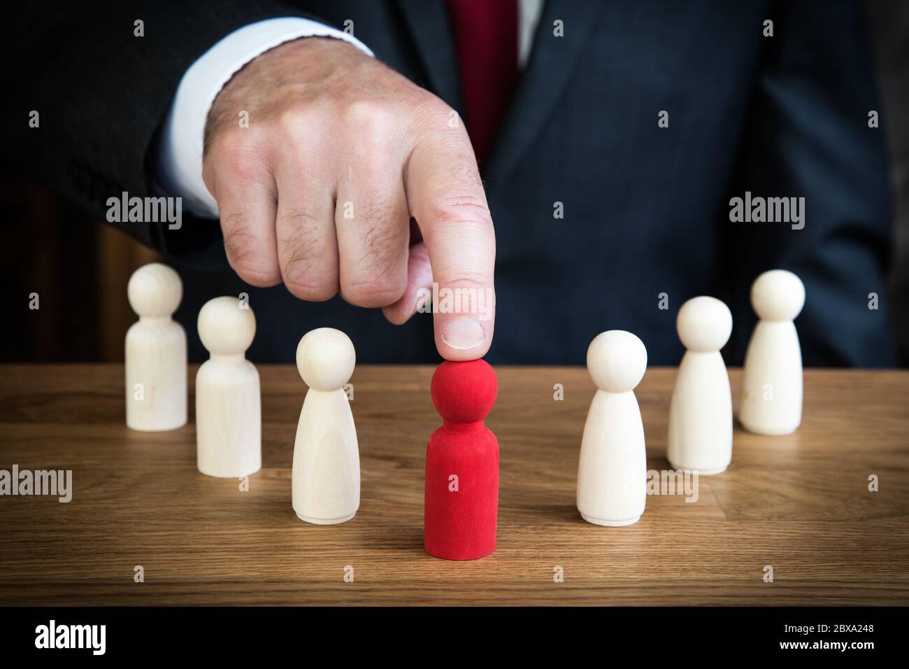 A businessman choosing or headhunting a team member for promotion to a leadership or management career position. Stock Photo