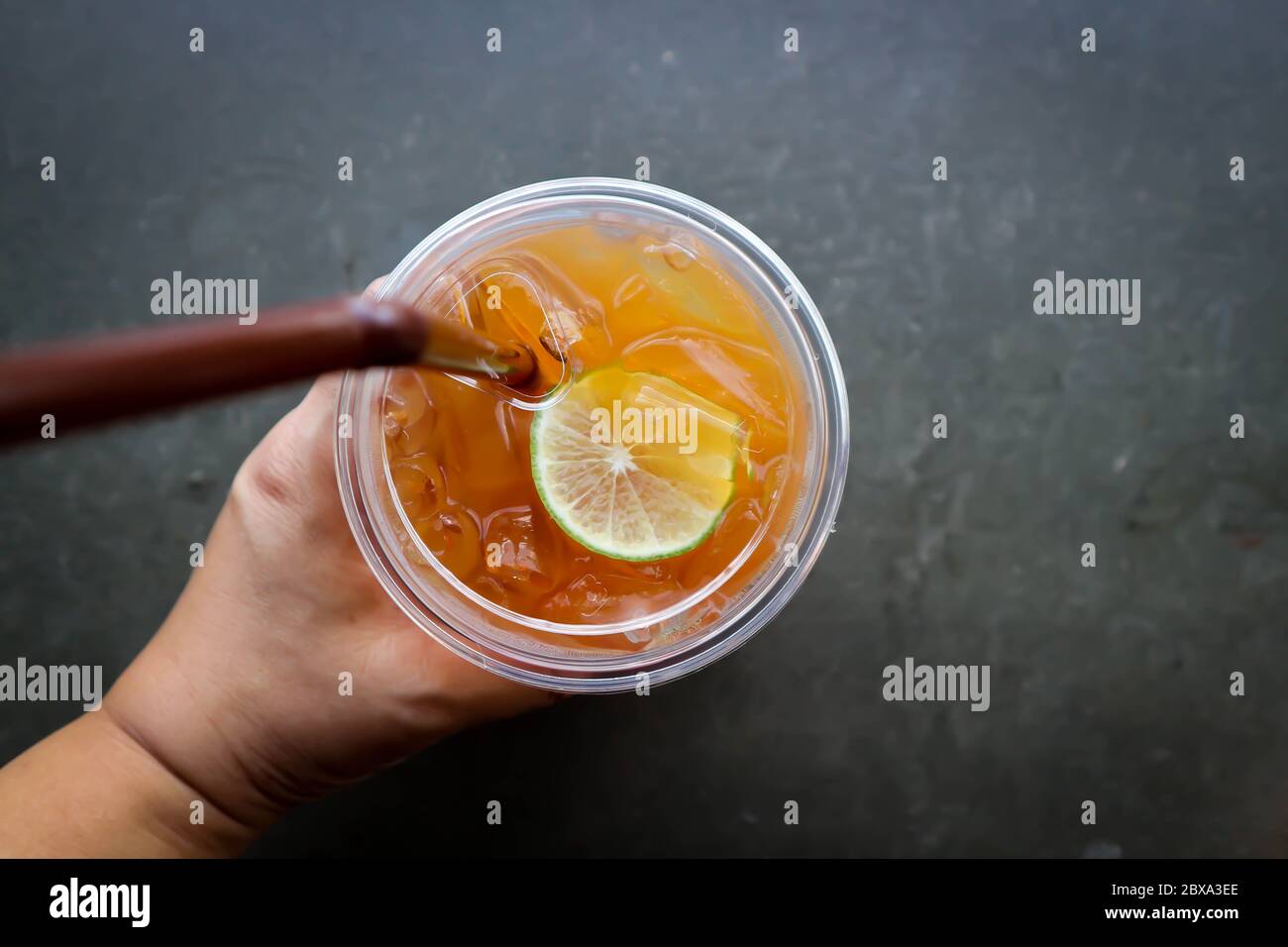 Plastic glass of lemon ice tea Stock Photo - Alamy