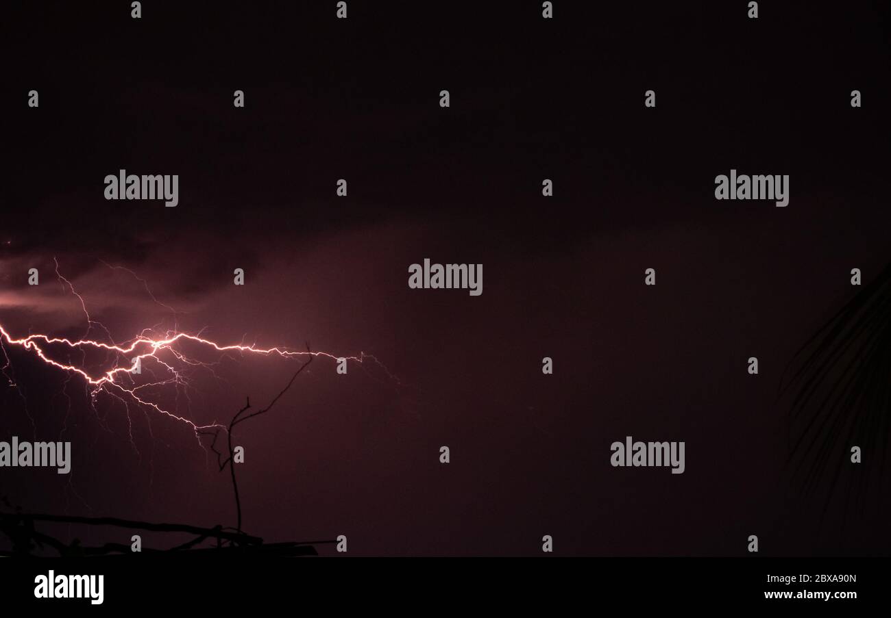 Lightning storm over the city buildings. Lightning bolt strike during a