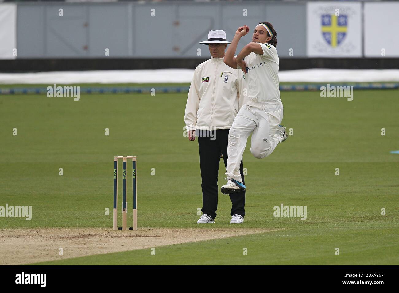 CHESTER LE STREET, ENGLAND - Jack Brooks of Yorkshire bowling and Alex Wharf umpiring during the County Championship match between Durham and Yorkshire at the Emirates Riverside, Chester le Street, County Durham on Monday 5th May 2014 (Credit: Mark Fletcher | MI News) Stock Photo