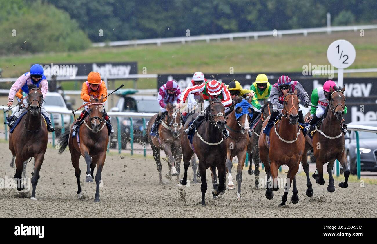 Desert Land ridden by Shane Kelly (orange) wins the Betway Heed Your Hunch Handicap at Lingfield Racecourse. Stock Photo