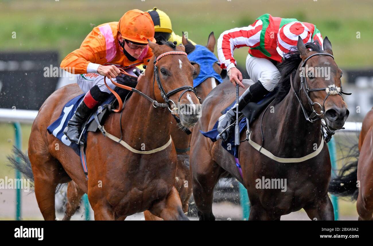 Desert Land ridden by Shane Kelly (orange) wins the Betway Heed Your Hunch Handicap at Lingfield Racecourse. Stock Photo