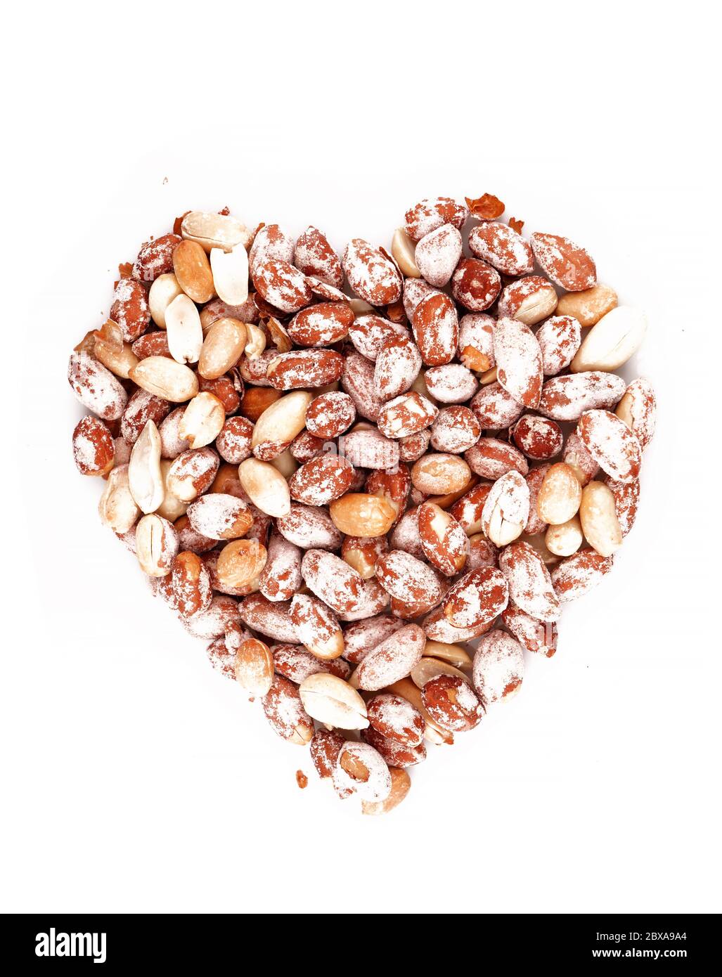 Organic Salted Peanuts in heart symbol isolated on white background Stock Photo