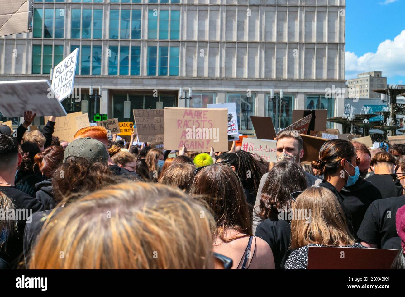 Protestors and 'Make racists afraid again' sign at a Black Lives Matter protest following the death of George Floyd on Alexanderplatz Berlin, Germany. Stock Photo